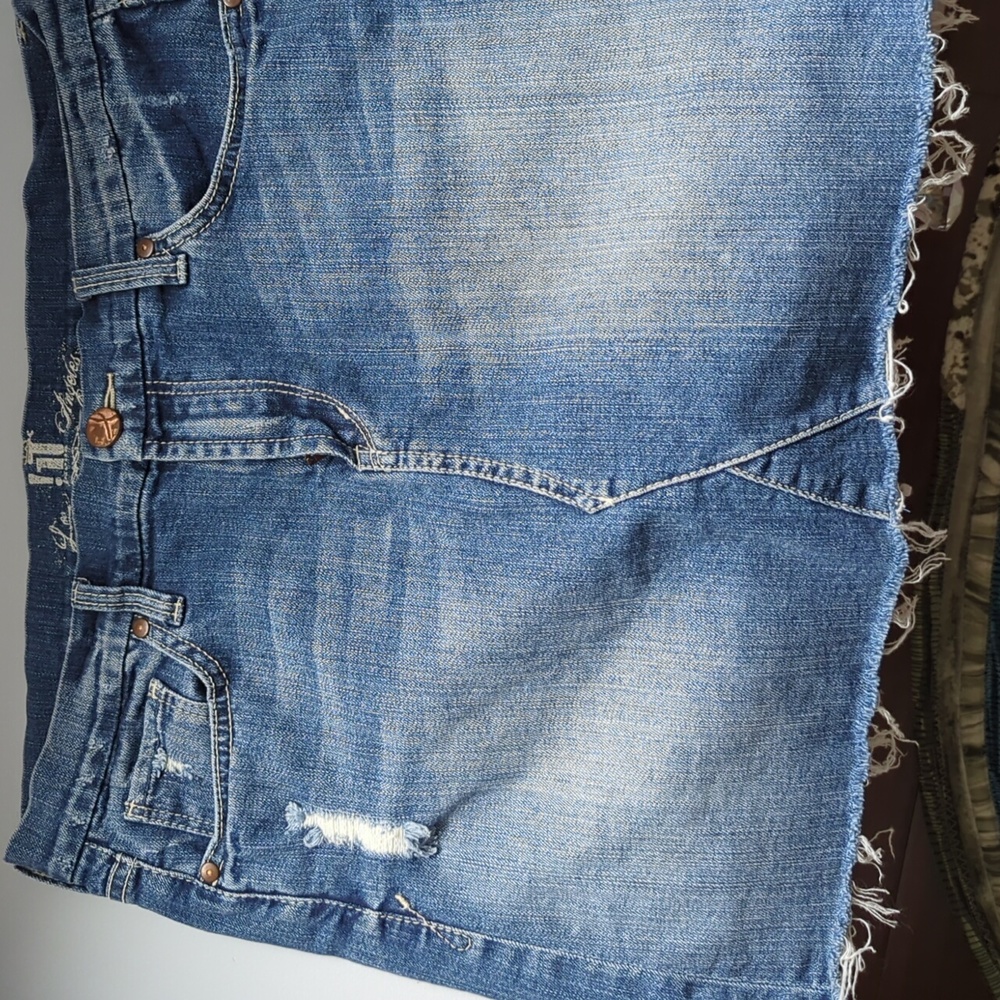 Distressed denim mini skirt